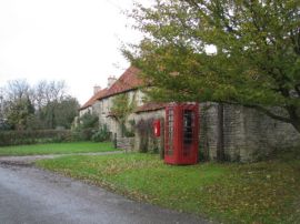 A red phone box and a cottage